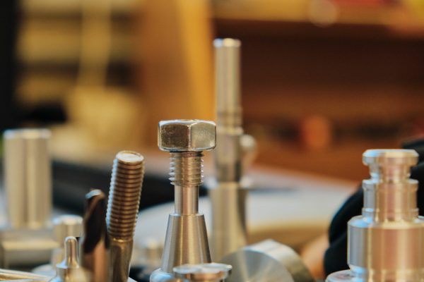 A collection of stainless steel screws of various sizes along engineering threads and metal